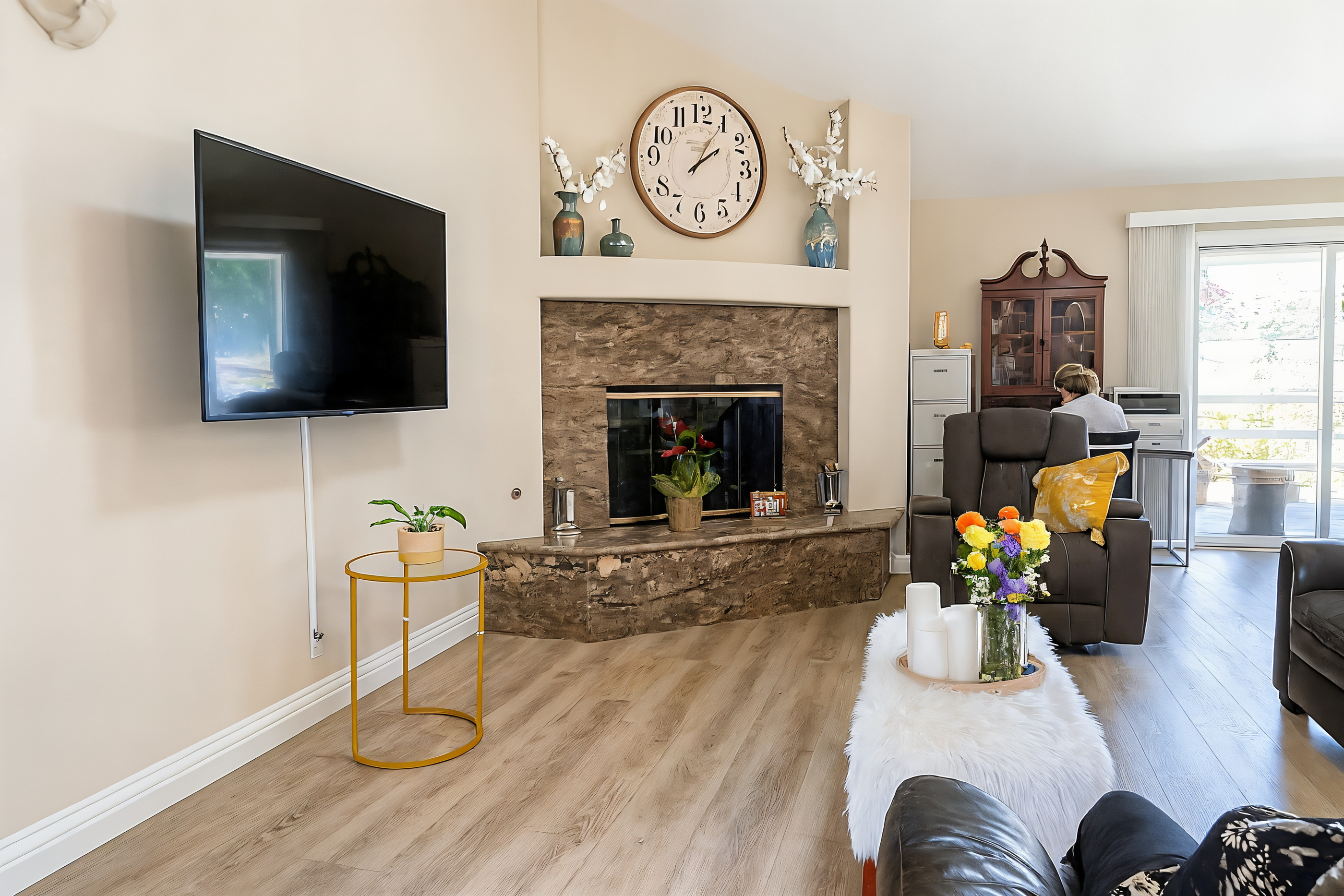 Warm living room with a stone fireplace and comfortable seating